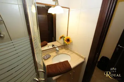 a bathroom with a sink and a mirror at Royal Luxury Apartments & Studios in Amman