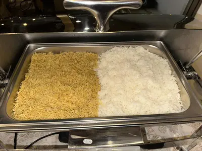 a tray filled with rice in an oven at Petra Sky Hotel in Wadi Musa