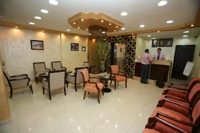 a man standing at a counter in a salon at Cedar Hotel in Aqaba