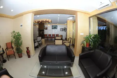 a salon with black leather chairs and a waiting room at Cedar Hotel in Aqaba
