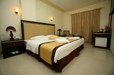 a bedroom with a large bed in a room at Cedar Hotel in Aqaba