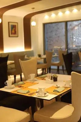 a dining room with a table and chairs at Hilton Amman in Amman