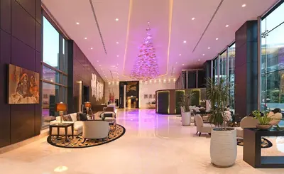 a lobby with a christmas tree in a building at Hilton Amman in Amman