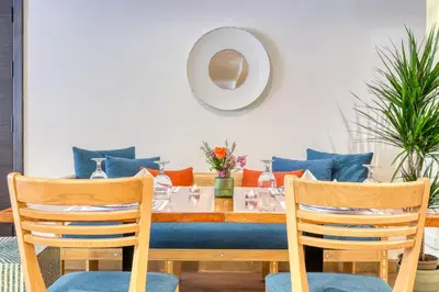 a dining room with a table and two chairs at The Liwan Hotel in Amman