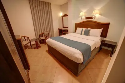 a bedroom with a large bed in a hotel room at Crystal Hotel By FHM in Aqaba