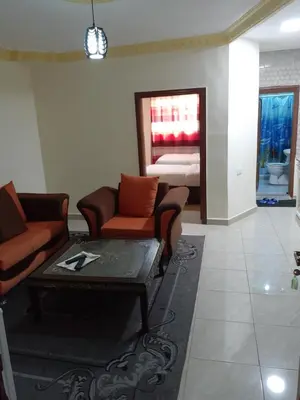 a living room with a couch and a table and a bed at Petra Visitors Hotel in Wadi Musa