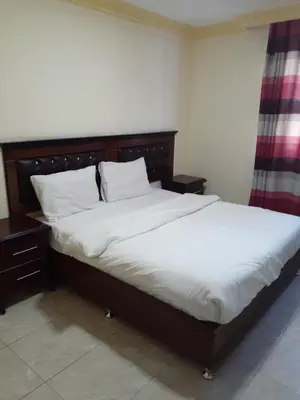 a bedroom with a large bed with white sheets at Petra Visitors Hotel in Wadi Musa