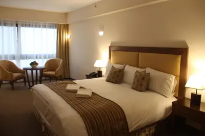 a hotel room with a large bed and a desk at Saray Hotel Amman in Amman