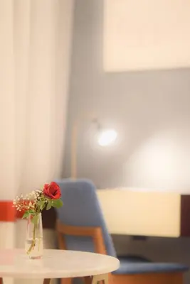 a vase with a rose sitting on top of a table at Petra Boutique Hotel in Wadi Musa
