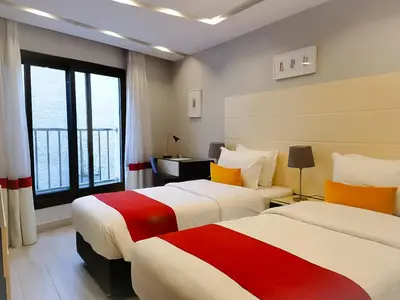 a hotel room with two beds and a window at Petra Boutique Hotel in Wadi Musa