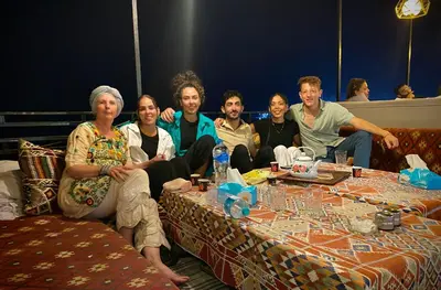 a group of people sitting around a table at Al-Amer Hostel 1 in Aqaba
