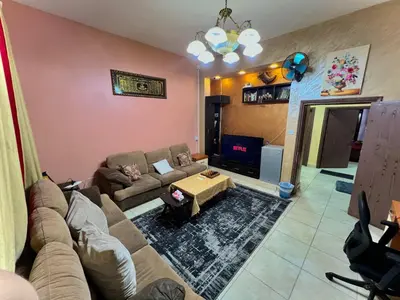 a living room with a couch and a table at Al-Amer Hostel 1 in Aqaba