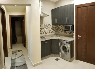 a kitchen with a washing machine and a sink at Marmaris Hotel Apartments in Amman