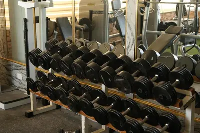 a rack of dumbbells in a gym at Grape Village Hotel in Amman