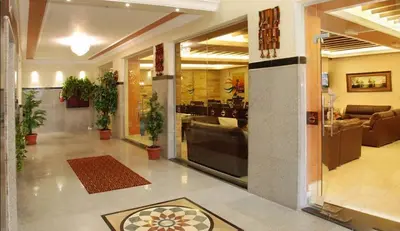a lobby with potted plants in a building at Jardaneh Hotel in Aqaba