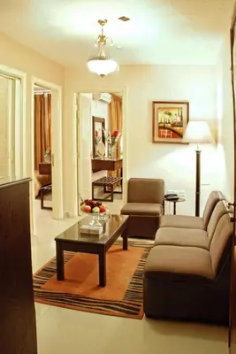 a living room with a couch and a coffee table at Jardaneh Hotel in Aqaba