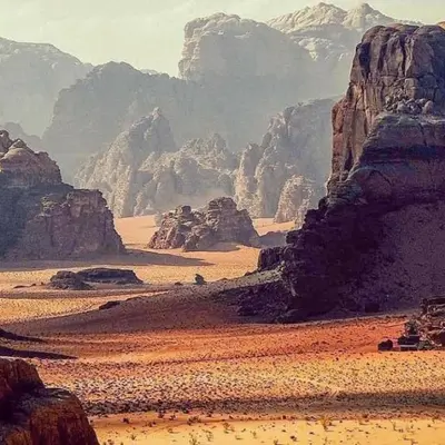 a view of a desert with rocks and mountains at Bedouin Village Hostel in Wadi Rum
