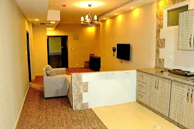 a kitchen with a living room with a couch at Skylight apartments in Amman