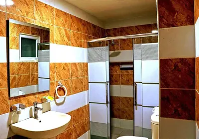 a bathroom with a sink and a shower at Skylight apartments in Amman