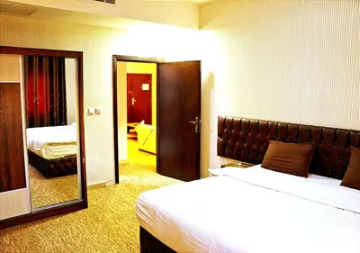a hotel room with a bed and a mirror at Skylight apartments in Amman