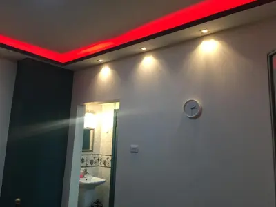 a bathroom with a red light on the ceiling at Nobel Hotel in Amman