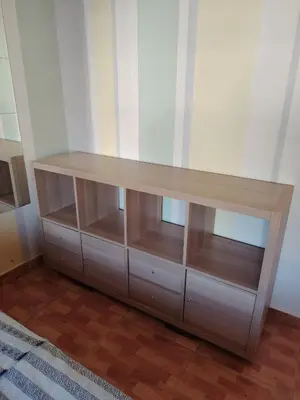 a wooden dresser in a room with a shelf at Abu alzoz home سكن مشترك in Amman