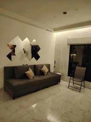 a living room with a couch and a chair at Abu alzoz home سكن مشترك in Amman