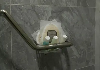 a towel holder in a bathroom with toiletries at Al Jawhara Hotel Suites in Amman