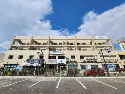 a building with a parking lot in front of it at Aquavista Hotel & Suites in Aqaba