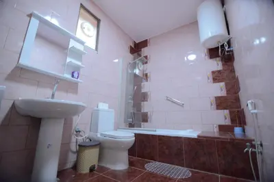 a bathroom with a toilet and a sink at Juniper House in Wadi Musa