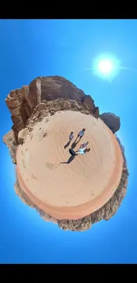 a cake with people playing in the sand on a beach at Bronze Mountains Camp Wadi Rum in Aqaba