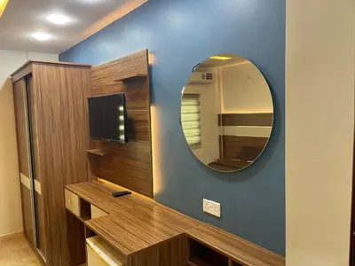 a bathroom with a mirror and a tv on a wall at Al Deyafa Hotel in Aqaba