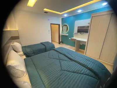 a bedroom with a bed and a sink in it at Al Deyafa Hotel in Aqaba