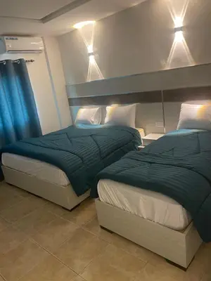 two beds sitting next to each other in a bedroom at Al Deyafa Hotel in Aqaba