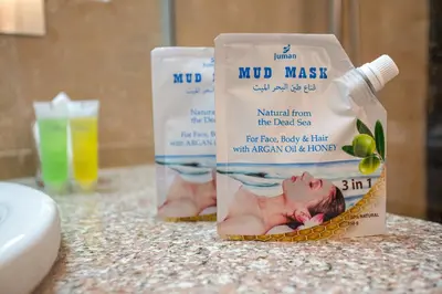 a bottle of mud master and a bottle of baby wash on a counter at Grand Hotel Madaba in Madaba