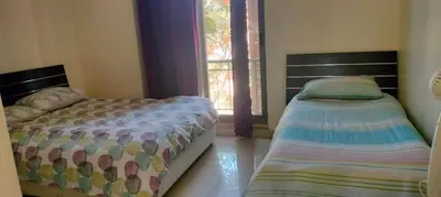 a bedroom with two beds and a window at Sea View Apartment at Tala Bay Resort in Aqaba in Aqaba