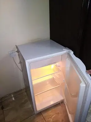 an empty refrigerator with its door open in a room at Aqaba Roza in Aqaba