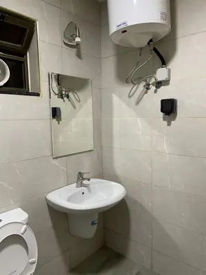 a bathroom with a toilet and a sink and a mirror at Aqaba Roza in Aqaba