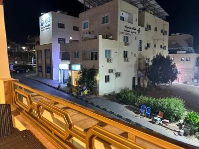 a view of a building from a balcony at Relax House For Studio Rooms Apartments ريلاكس هاوس للشقق المفروشة in Aqaba
