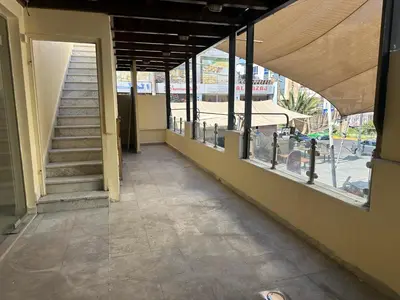 a hallway of a building with a staircase and windows at Relax House For Studio Rooms Apartments ريلاكس هاوس للشقق المفروشة in Aqaba