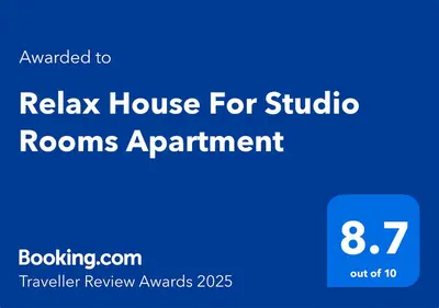 a blue sign that reads relax house for studio rooms apartment at Relax House For Studio Rooms Apartments ريلاكس هاوس للشقق المفروشة in Aqaba
