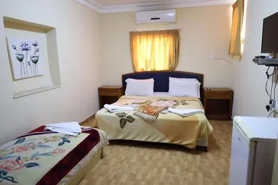 a hotel room with a bed and a window at Dweik Hotel 1 in Aqaba