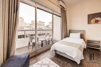 a bedroom with a bed and a large window at Hotel magic aqaba in Aqaba