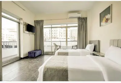 a hotel room with two beds and a large window at Hotel magic aqaba in Aqaba