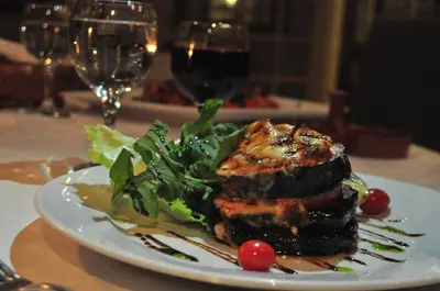a plate of food with meat and vegetables on a table at Bonita Inn in Amman