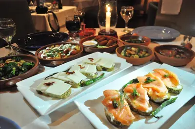 a table with plates of food and bowls of food at Bonita Inn in Amman