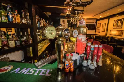 a bar with bottles of alcohol on a counter at Bonita Inn in Amman