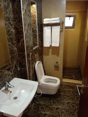 a bathroom with a toilet and a sink at seven7days hotel in Aqaba