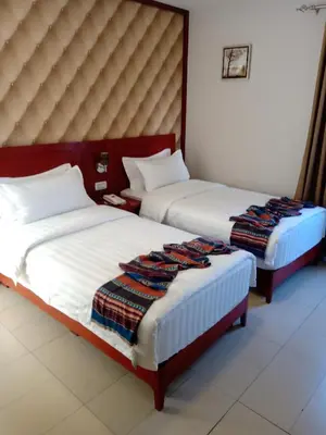 two beds sitting next to each other in a room at seven7days hotel in Aqaba