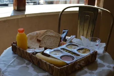 a basket of food with bread and a bottle of orange juice at seven7days hotel in Aqaba